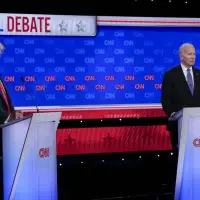 A raspy and sometimes halting Biden tries at debate to confront Trump, who responds with falsehoods