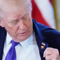 Trump wears a new 'Happy Trump' lapel pin, but insists he's never happy