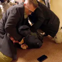 Man sprays unknown substance on Rep. Ilhan Omar and is tackled at Minneapolis town hall