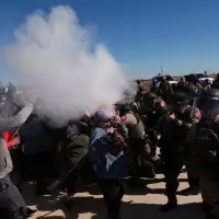 Officers confront protesters at Texas facility as lawmaker visits father, son detained in Minnesota