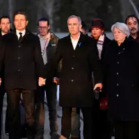 Mark Carney joins hands with Canada opposition leader as he pays tribute to school shooting victims