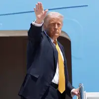 The Latest: Trump arrives in China to meet with Xi in Beijing