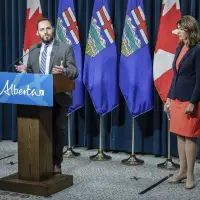 Alberta delaying new restrictions on flags in schools, national anthem mandate