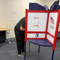 The Latest: Early midterm voting gets underway with control of Congress at stake
